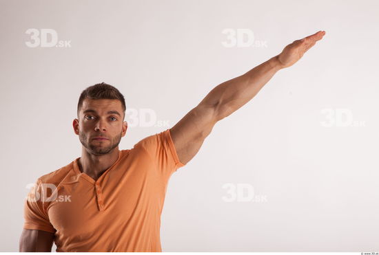 Arm moving pose orange thsirt of bodybuilder Harold