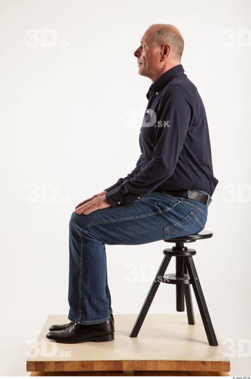 Sitting pose blue deep shirt jeans of Ed