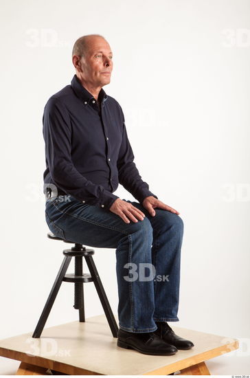 Sitting pose blue deep shirt jeans of Ed
