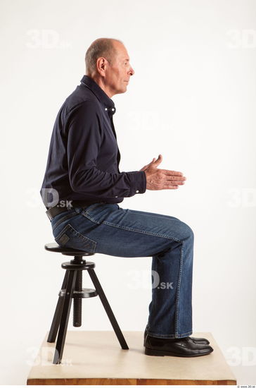 Sitting pose blue deep shirt jeans of Ed