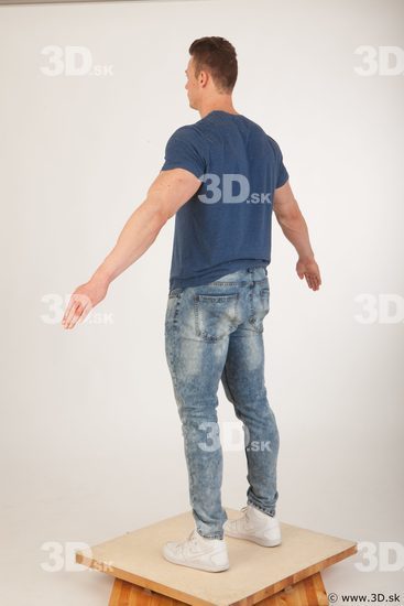 Whole body blue tshirt light blue jeans modeling a pose of Andrew