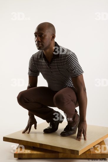 Kneeling reference of whole body black white striped shirt brown jeans brown shoes Arturo