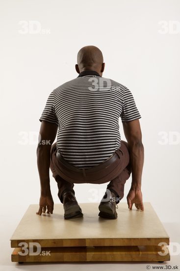 Kneeling reference of whole body black white striped shirt brown jeans brown shoes Arturo