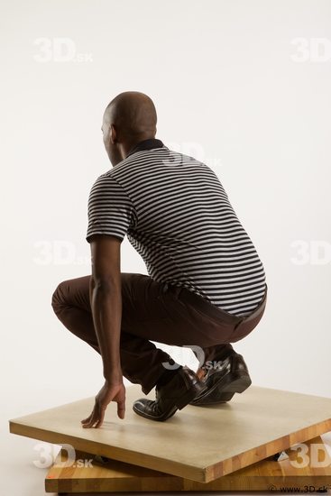 Kneeling reference of whole body black white striped shirt brown jeans brown shoes Arturo