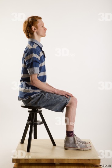 Sitting reference of whole body striped blue gray shirt blue jeans shorts black gray shoes Wesley