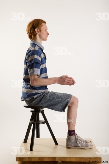 Sitting reference of whole body striped blue gray shirt blue jeans shorts black gray shoes Wesley