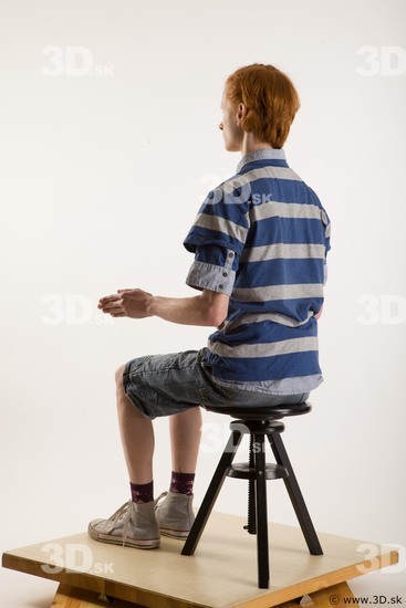 Sitting reference of whole body striped blue gray shirt blue jeans shorts black gray shoes Wesley