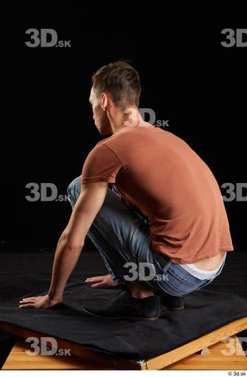 Alessandro Katz  black shoes blue jeans brown t shirt casual dressed kneeling whole body  jpg