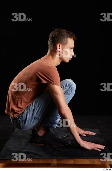 Alessandro Katz  black shoes blue jeans brown t shirt casual dressed kneeling whole body  jpg