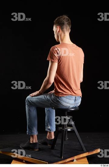 Alessandro Katz  black shoes blue jeans brown t shirt casual dressed sitting whole body  jpg