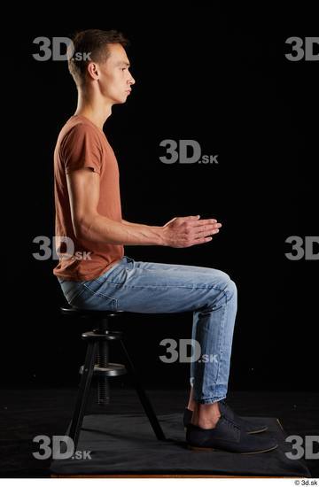 Alessandro Katz  black shoes blue jeans brown t shirt casual dressed sitting whole body  jpg