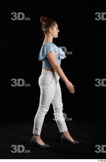 Serina Gomez  blue carmen shirt casual dressed grey high heels side view walking white trousers whole body  jpg