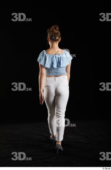 Serina Gomez  back view blue carmen shirt casual dressed grey high heels walking white trousers whole body  jpg