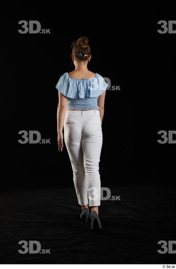 Serina Gomez  back view blue carmen shirt casual dressed grey high heels walking white trousers whole body  jpg