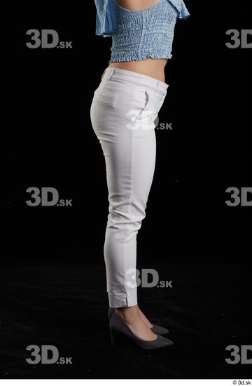 Serina Gomez  casual dressed flexing grey high heels leg side view white trousers  jpg