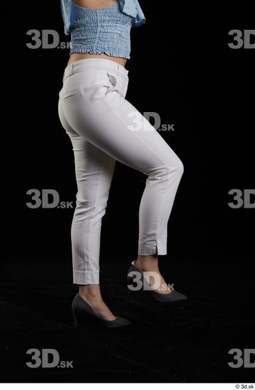 Serina Gomez  casual dressed flexing grey high heels leg side view white trousers  jpg