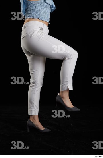 Serina Gomez  casual dressed flexing grey high heels leg side view white trousers  jpg