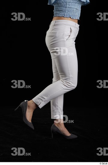 Serina Gomez  casual dressed flexing grey high heels leg side view white trousers  jpg