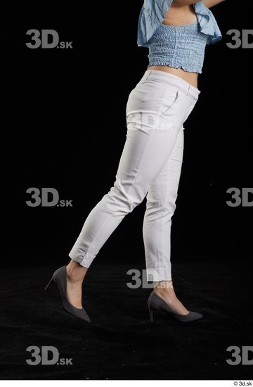 Serina Gomez  casual dressed flexing grey high heels leg side view white trousers  jpg