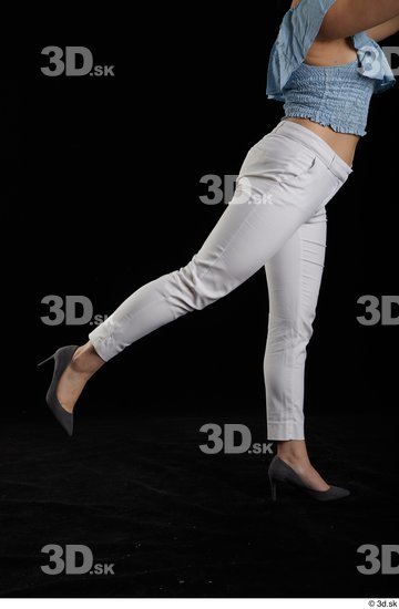 Serina Gomez  casual dressed flexing grey high heels leg side view white trousers  jpg