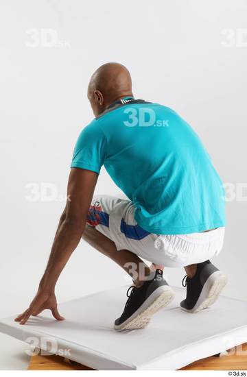 Whole Body Man Black Sports Shirt Shorts Slim Kneeling Studio photo references