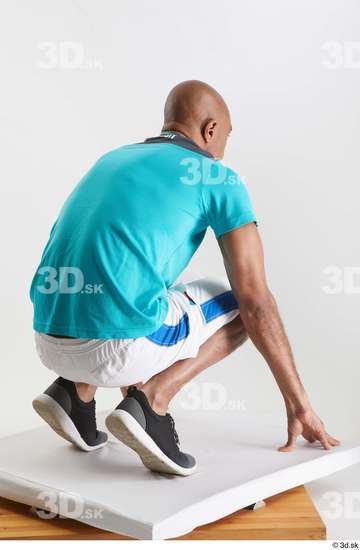 Whole Body Man Black Sports Shirt Shorts Slim Kneeling Studio photo references